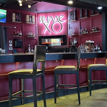Prime XO - a bar with chairs and a television - Seafood Near Me - Forney, Texas