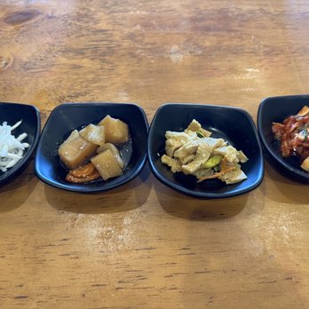 Sura - Banchan (from left to right: pickled radish, candied potatoes, fish cakes, Kimchi) - Korean Near Me - Oxnard, California Sura - Banchan (from left to right: pickled radish, candied potatoes, fish cakes, Kimchi) - Korean Near Me - Oxnard, California