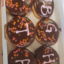 six donuts with chocolate frosting and sprinkles six donuts with chocolate frosting and sprinkles