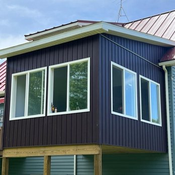 Saylor Builders - a blue house with a red roof - Roofing Near Me - Allegan, Michigan