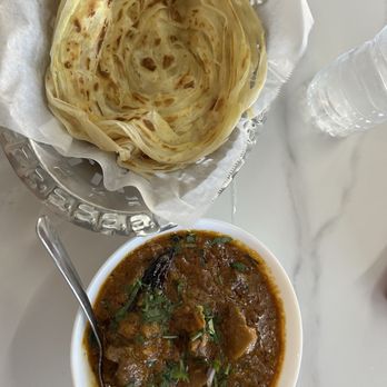 Nawabi Hyderabad House - Flaky paratha with goat curry - Indian Near Me - Austin, Texas Nawabi Hyderabad House - Flaky paratha with goat curry - Indian Near Me - Austin, Texas