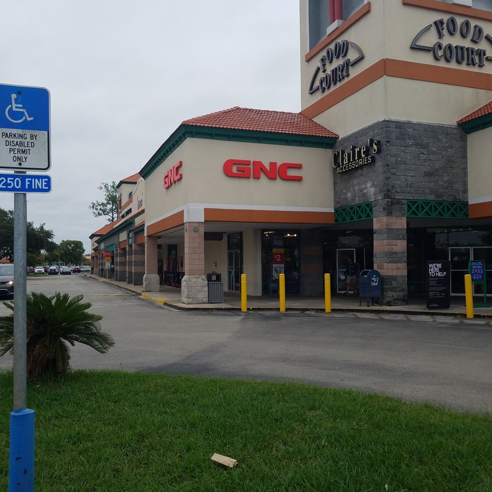 GNC - a parking lot with a sign in front of it - Health Markets Near Me - St Augustine, Florida