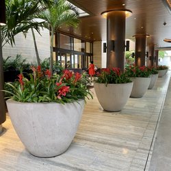 Cast Stone International - Highly polished cast stone planters. Designed and purposed to fill the empty space with a modern design and vibrant color flowers.