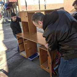 PCMR - Co-Founder Max Ridenhour guiding the front while Co-Founder Patrick Cymer and his father push a desk to the new location at 209 N Holden St.