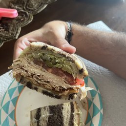 a person holding a sandwich
