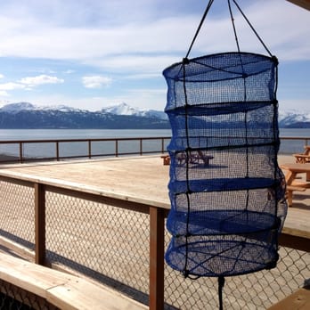 Kachemak Shellfish Growers Coop - A lantern net on display in front of the co-op's deck where you can sit at the picnic tables and shuck your own oysters. - Seafood Markets Near Me - Homer, Alaska Kachemak Shellfish Growers Coop - A lantern net on display in front of the co-op's deck where you can sit at the picnic tables and shuck your own oysters. - Seafood Markets Near Me - Homer, Alaska