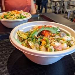 Front: Large poke bowl (4 proteins, 2 sides, $13.95) plus kale noodles ($1), avocado ($1). Back: Small bowl (2 proteins, 2 sides, $9.95). Front: Large poke bowl (4 proteins, 2 sides, $13.95) plus kale noodles ($1), avocado ($1). Back: Small bowl (2 proteins, 2 sides, $9.95).