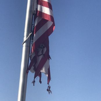Carl's Jr - Notice knots in torn flag - Fast Food Near Me - Baker, California