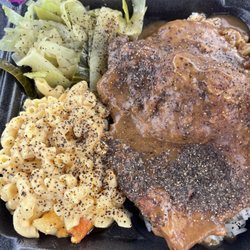 The House Of Soul Food - Smothered pork chop over white rice, mac and cheese and cabbage