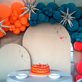 Little Sugar Crumb Sweets - Orange and pink vintage-style wedding cake that says Just Hitched with disco balls for decoration at El Pais Motel in Tucson, Arizona - Custom Cakes Near Me