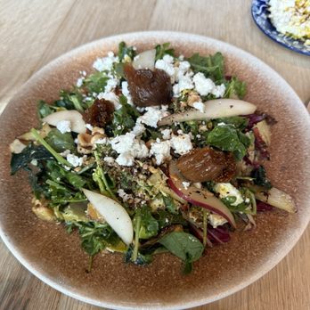Ladino - FIRE: it has a date vinaigrette but this is not sweet. The figs and pear give pops of sweet but it's bitter and tangy. So good - Mediterranean Near Me - San Antonio, Texas
