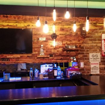 Genesis - a bar with a television mounted on a brick wall - Karaoke Near Me - Queens, New York Genesis - a bar with a television mounted on a brick wall - Karaoke Near Me - Queens, New York
