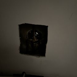 Beachpoint Cottages - Closer with multiple holes in wall with an awful musty smell.