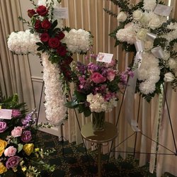 Heather & Vine Fine Floral Design - Funeral arrangement. White cross so small we almost missed it