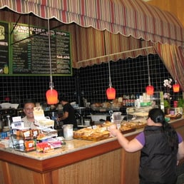 a woman ordering food at a counter a woman ordering food at a counter