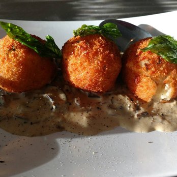 Nuovo Bistro - Arancini  Crispy risotto balls stuffed with fontina cheese, basil, mushroom parmigiano cream & crispy basil - Italian Near Me - Edmonton, Alberta