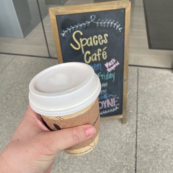 Spaces Cafe - a hand holding a cup of coffee - Coffee & Tea Near Me - Irvine, California