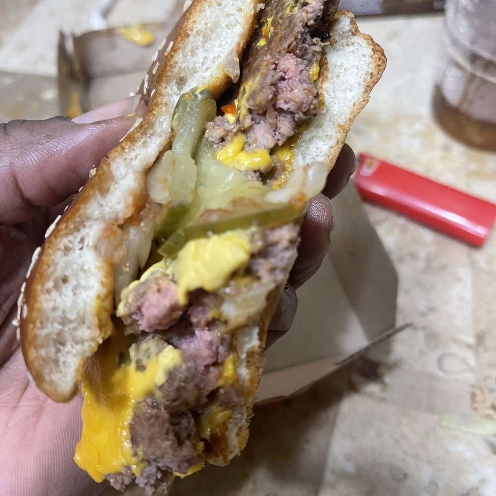 McDonald's - a person holding a sandwich in their hand - Fast Food Near Me - Ocala, Florida