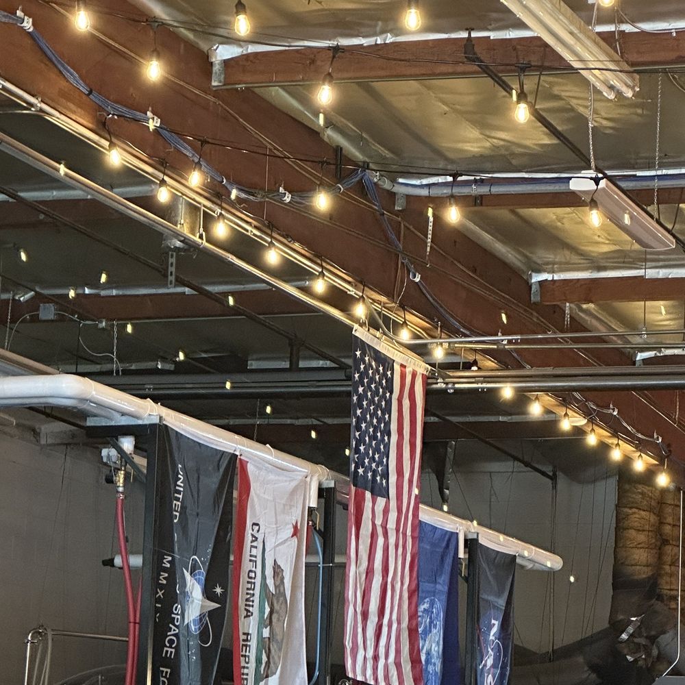 Mars Brewing - the interior of a brewery with american flags hanging from the ceiling - Breweries Near Me - Rancho Cucamonga, California Mars Brewing - the interior of a brewery with american flags hanging from the ceiling - Breweries Near Me - Rancho Cucamonga, California