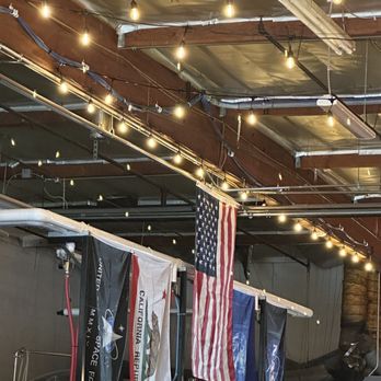 Mars Brewing - the interior of a brewery with american flags hanging from the ceiling - Breweries Near Me - Rancho Cucamonga, California Mars Brewing - the interior of a brewery with american flags hanging from the ceiling - Breweries Near Me - Rancho Cucamonga, California