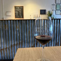 Birds and Barrels tasting room - Serving bar and a glass of cab sauv