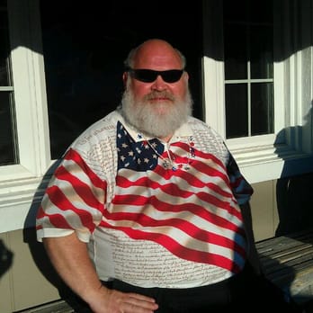 Art's Tavern - Tim Barr, owner of Art's Tavern, celebrating on July 4th. He's the host on most nights. - Bars Near Me - Glen Arbor, Michigan Art's Tavern - Tim Barr, owner of Art's Tavern, celebrating on July 4th. He's the host on most nights. - Bars Near Me - Glen Arbor, Michigan