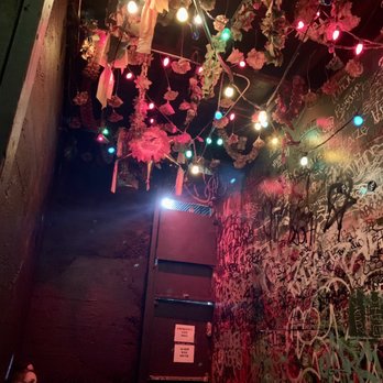 Bimbos Cantina - a woman sitting in a room with graffiti on the walls - Mexican Near Me - Seattle, Washington