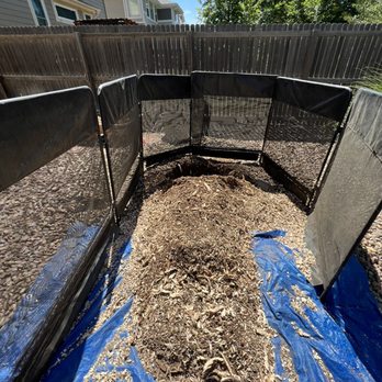 A1 Stump Removal - This is what the stump look like after it was ground down. The hole caught some of the debris and the tarp caught the rest. - Tree Services Near Me - Arvada, Colorado
