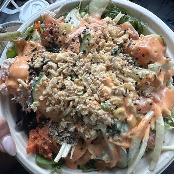 PokeHub - a person holding a bowl of food - Poke Near Me - Reston, Virginia