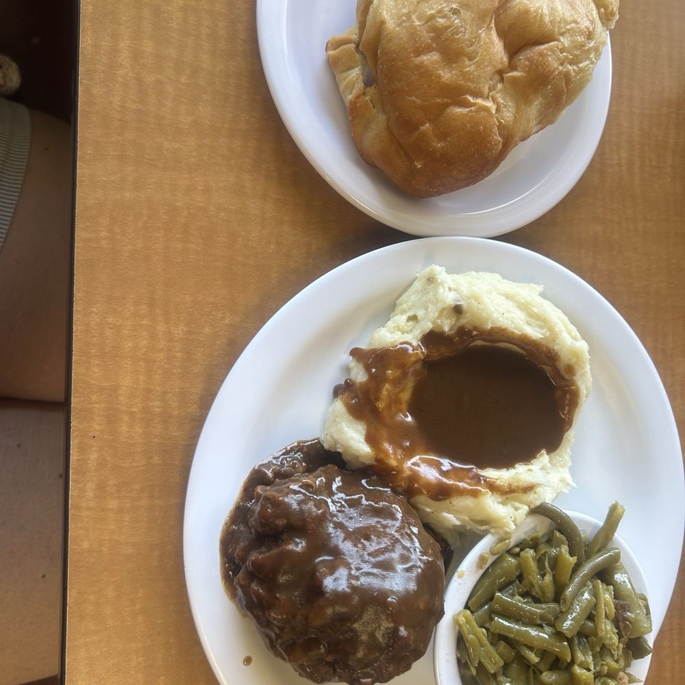 Salisbury steak green beans, mashed potatoes, brown gravy, and yeast roll