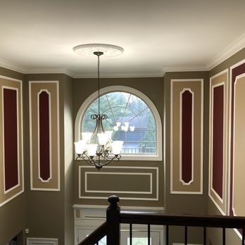 JJMS Construction - a hallway with a chandelier and a window - General Contractors Near Me - Edison, New Jersey