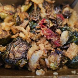 Johnny’s Garage - Crispy brussel sprouts: oven dried tomatoes, sweet garlic chili vinaigrette, & crispy onions.