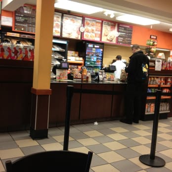 Dunkin' -  a man standing at a counter in a restaurant - Coffee & Tea Near Me - Bronx, New York