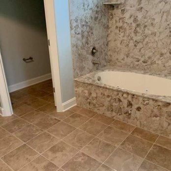 Panos Contracting - a bathroom with a bathtub and shower - General Contractors Near Me