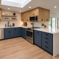 Pacific Kitchens Inc - Stained solid 'select white' maple & blue "Thermofoil" refacing on flat doors & drawer fronts with Quartz countertops.