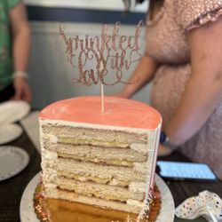One Love Bakery - 8 inch cake (single tier, round, 5 layers tall). Vanilla with strawberry jam filling and vanilla cream filling, and vanilla buttercream.