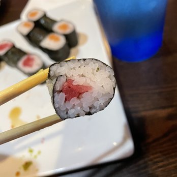 Sushi Mon - chopsticks holding up a piece of sushi - Sushi Bars Near Me - Midlothian, Virginia Sushi Mon - chopsticks holding up a piece of sushi - Sushi Bars Near Me - Midlothian, Virginia