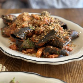 DPNB Pasta & Provisions - Squid ink paccheri: Fresh DPNB Squid ink Paccheri served with octopus ragu (tomato, olives, Aleppo, & oregano), topped with breadcrumbs. - Pasta Shops Near Me - Nyack, New York DPNB Pasta & Provisions - Squid ink paccheri: Fresh DPNB Squid ink Paccheri served with octopus ragu (tomato, olives, Aleppo, & oregano), topped with breadcrumbs. - Pasta Shops Near Me - Nyack, New York