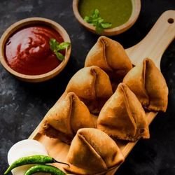 Delight Restaurant and Bar - Samosa: Crispy pastry filled with spiced potatoes and peas, a beloved Indian snack.