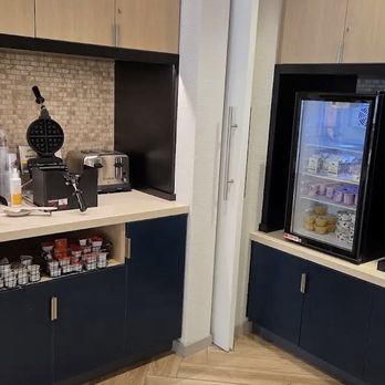 TownePlace Suites - Waffle station with regular size and mini size. Fridge with yogurts and juice dispenser on the right - Hotels Near Me - Pigeon Forge, Tennessee TownePlace Suites - Waffle station with regular size and mini size. Fridge with yogurts and juice dispenser on the right - Hotels Near Me - Pigeon Forge, Tennessee