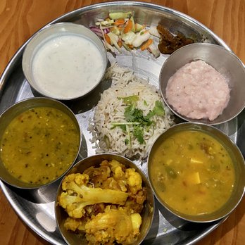 Thali - Thali with yogurt, pickled vegetables, rice, rice pudding, lentil soup, cauliflower/potato, paneer/peas - Indian Near Me - Reno, Nevada