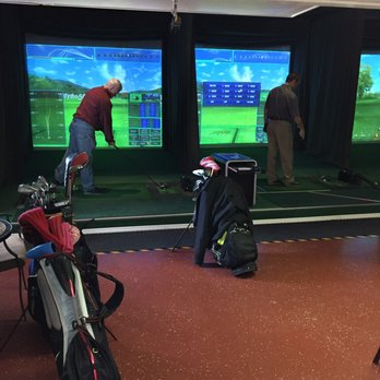 Golf Zone - two men playing golf on a large screen - Golf Near Me - Avon, Ohio Golf Zone - two men playing golf on a large screen - Golf Near Me - Avon, Ohio