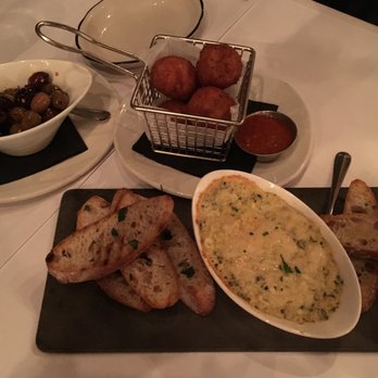 Cheesetique - A sampling of delicious small plates we had for starters: arancini, warm spinach-artichoke dip and spiced olives. - Cheese Shops Near Me - Alexandria, Virginia