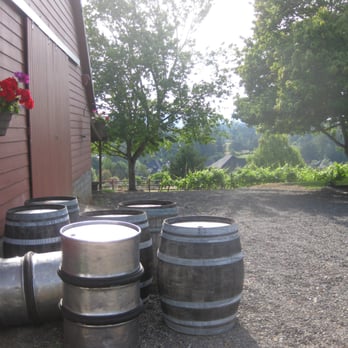 Springhill Cellars - a row of barrels with flowers in a hanging basket - Wineries Near Me - Albany, Oregon