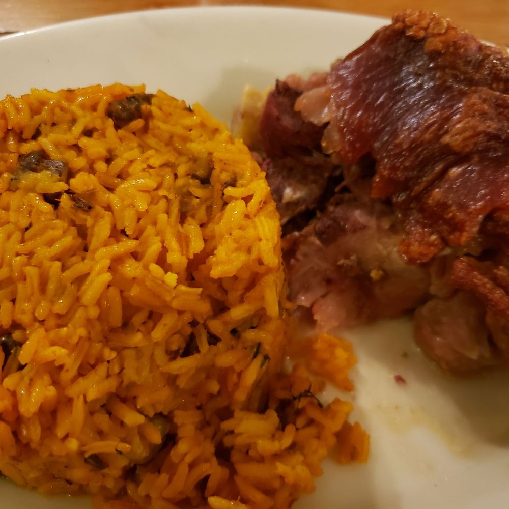 El Platanal - Pernil Al Horno (pork shoulder) with Arroz Apastelado (yellow rice with shredded plantains, chekpeas and olives) - Puerto Rican Near Me - San Juan, Puerto Rico