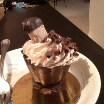 Frida's Cafe & Bakery - Tiramisu. Airy cookie dipped in chocolate on top of a layer of mascarpone cream with rum soaked lady finger in the bottom. - Bakeries Near Me - Largo, Florida Frida's Cafe & Bakery - Tiramisu. Airy cookie dipped in chocolate on top of a layer of mascarpone cream with rum soaked lady finger in the bottom. - Bakeries Near Me - Largo, Florida
