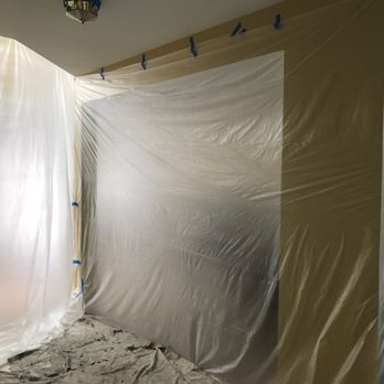 Edwin Painting Company - Plastic curtain tapped in open areas of the house connecting with entrance foyer, living and dining room, to protect from prep debris. - Painters Near Me