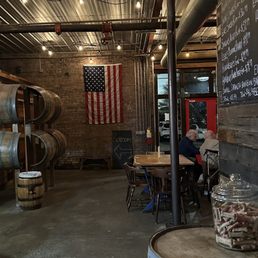 a man sitting at a table in a barrel