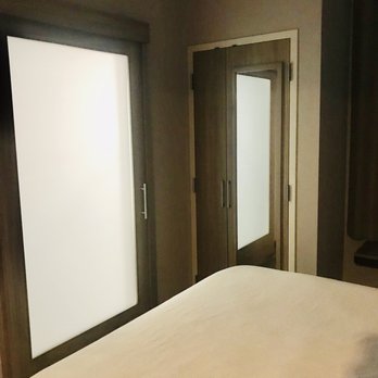 SpringHill Suites by Marriott Orangeburg - View to the bathroom (glass barn door) and spacious closet. - Hotels Near Me - Orangeburg, South Carolina SpringHill Suites by Marriott Orangeburg - View to the bathroom (glass barn door) and spacious closet. - Hotels Near Me - Orangeburg, South Carolina