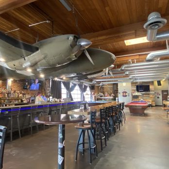 Hangar 101 - The bar is memorable with a plane hanging from the ceiling! - Sports Bars Near Me - Lakewood, Colorado Hangar 101 - The bar is memorable with a plane hanging from the ceiling! - Sports Bars Near Me - Lakewood, Colorado